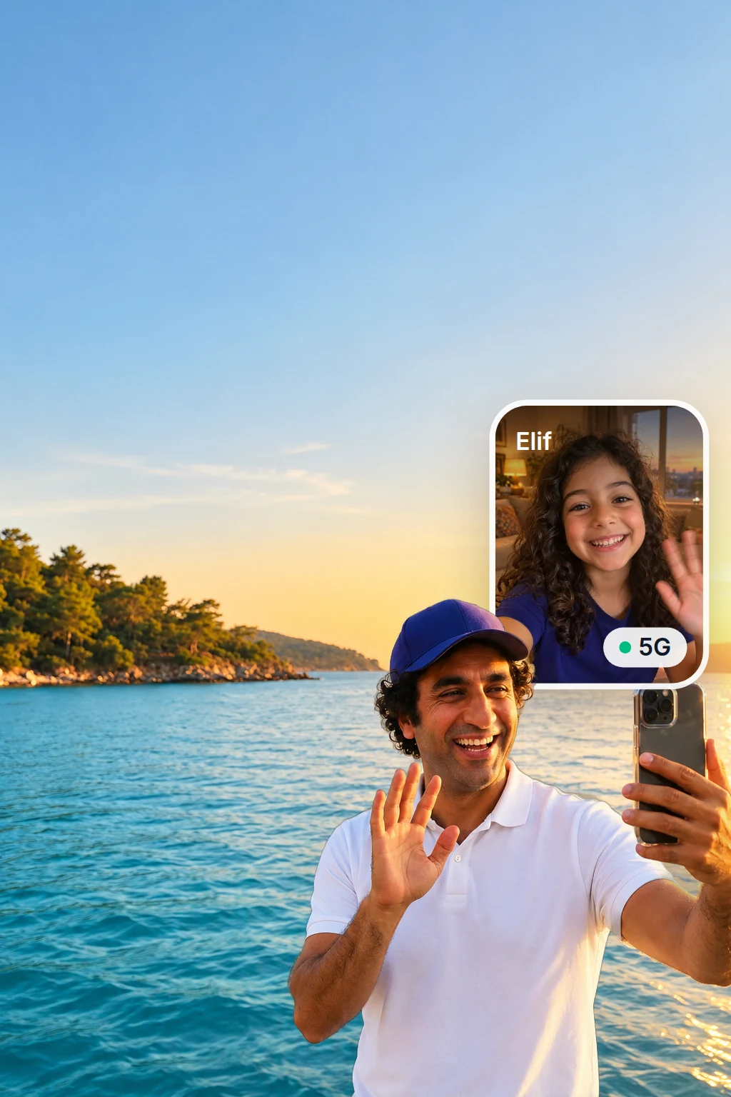 Man in an indigo cap laughing and waving at his phone on a video call with his daughter, standing by the sea on a beach in Türkiye at golden hour